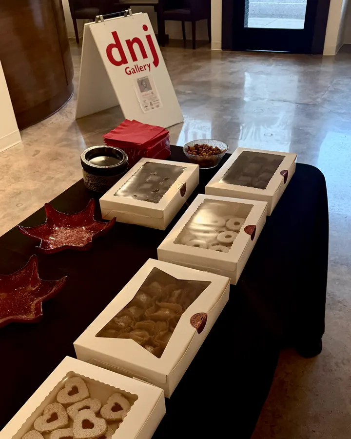 Belvedere Cookies boxes set out on a table beside the dnj Gallery sign