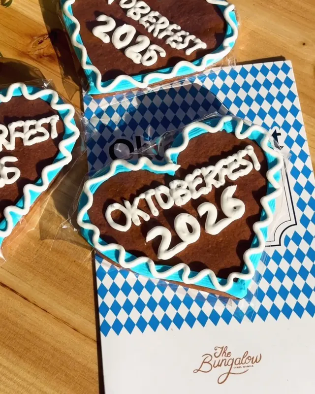 Gingerbread hearts with blue and white icing and Oktoberfest 2026 lettering beside The Bungalow card