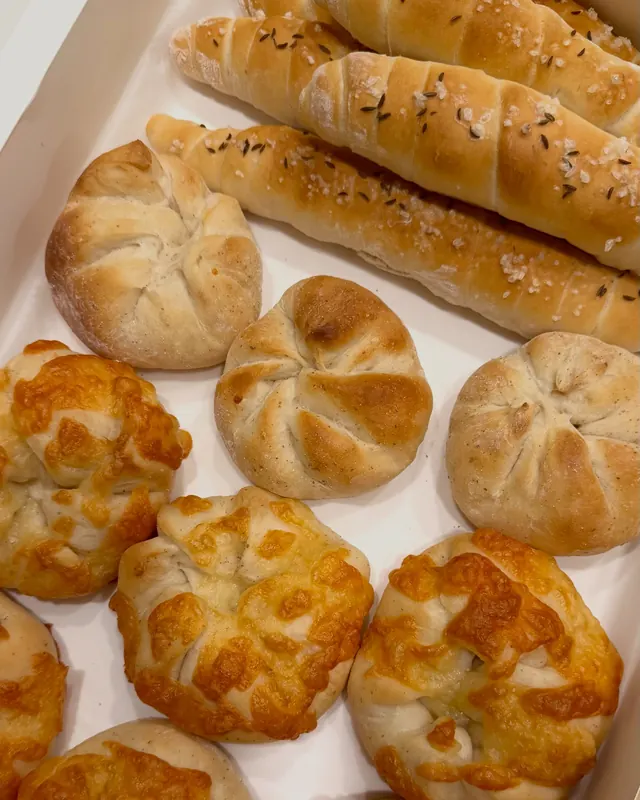 A tray of golden Austrian breakfast rolls and salt sticks from our company breakfast announcement
