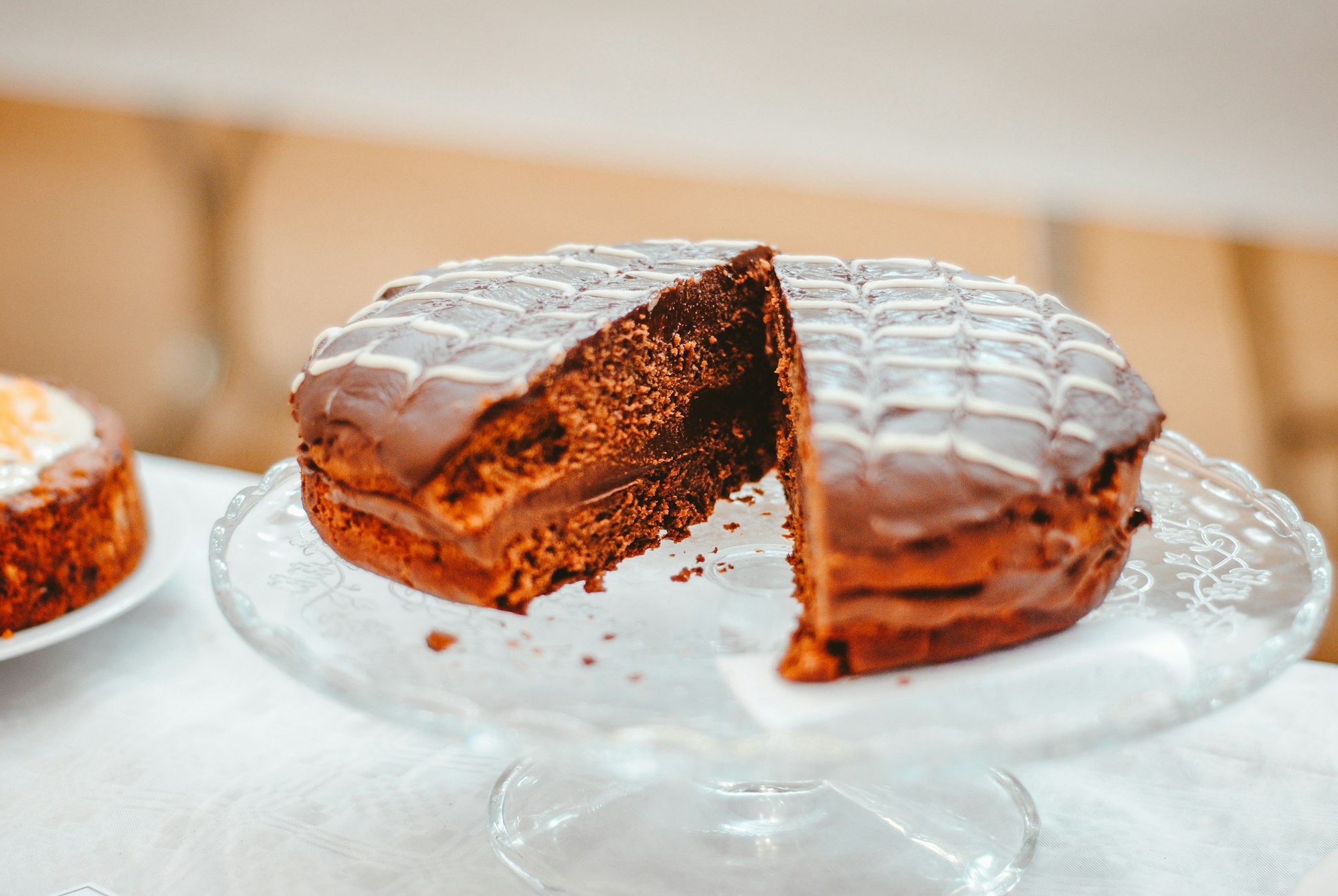 A slice of Austrian Sachertorte on a white plate, plated for a celebration